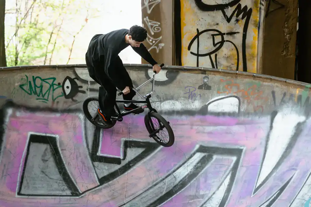 Coach helping a beginner rider drop into a small ramp