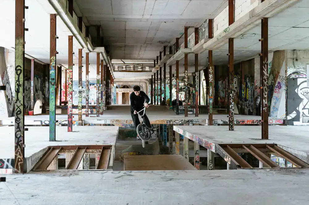 BMX rider catching air during an indoor session