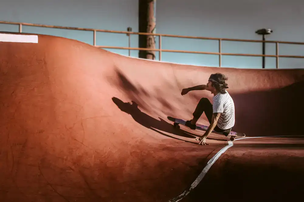 Skateboarder dropping into the technical bowl section
